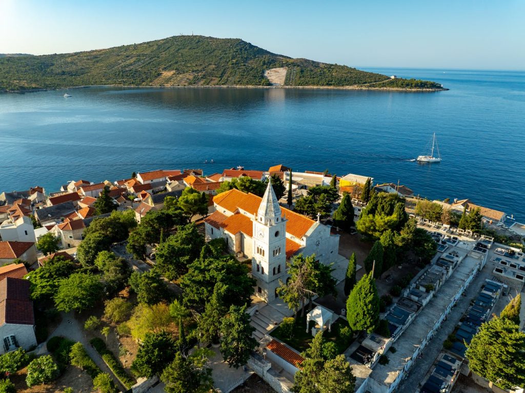 Stunning aerial view of Primošten, Croatia featuring historical architecture and serene coastal waters.